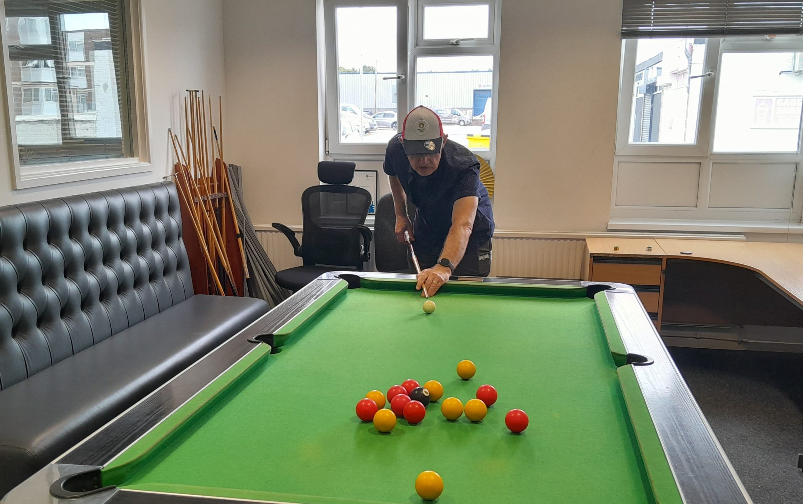 Male playing pool in wellbeing centre